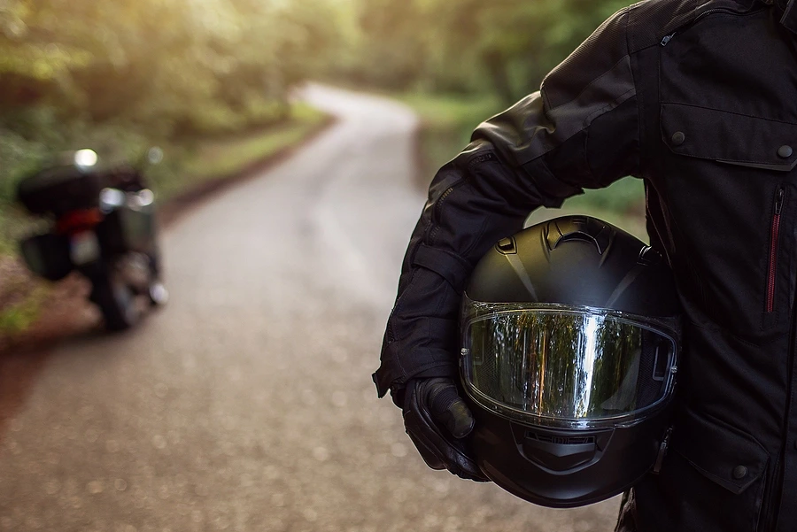 Rider holding motorcycle helmet